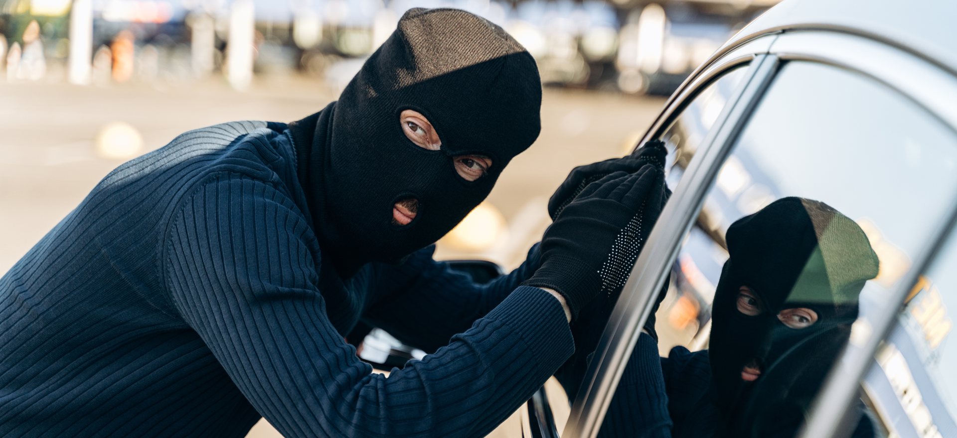 a thief tries to break into a car