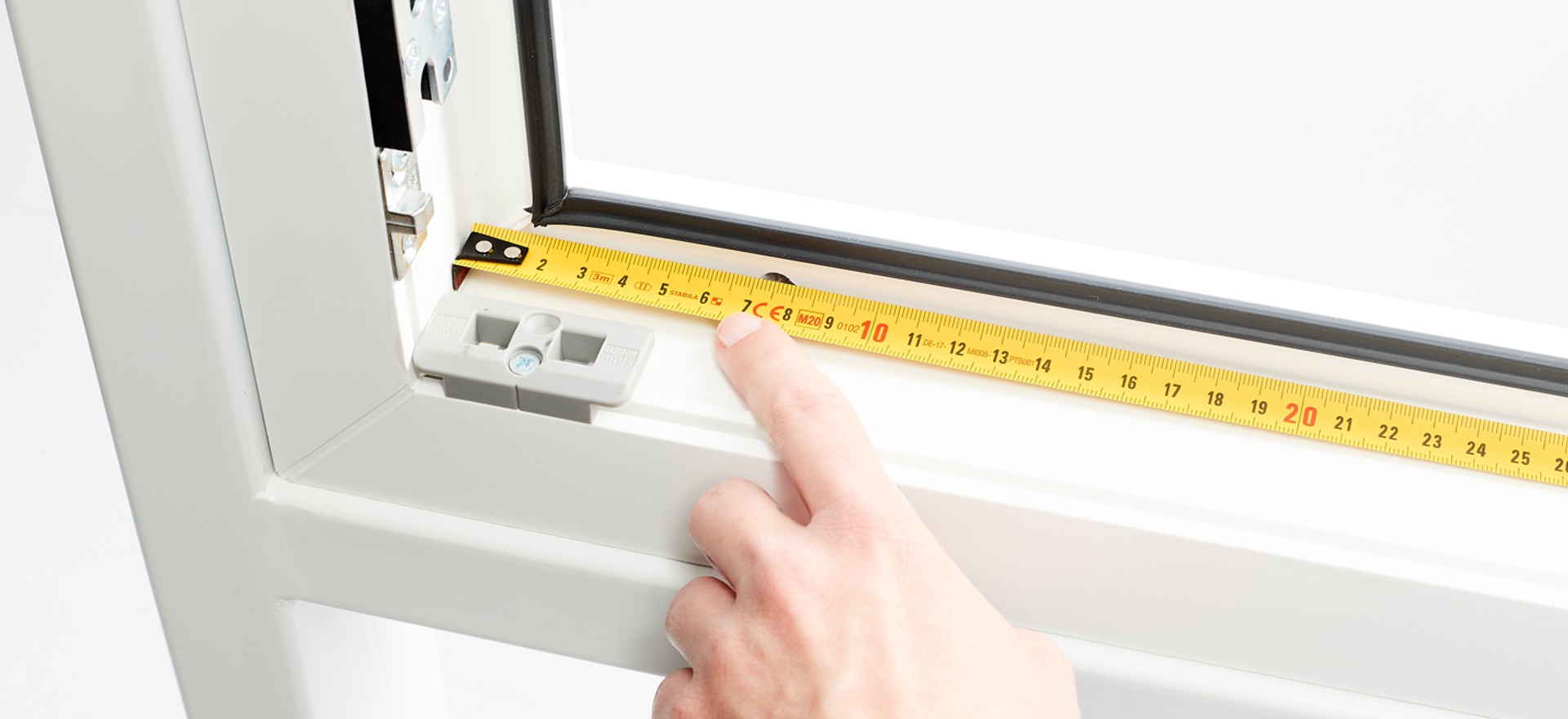 Custom-made fly screens - optimal insect protection a tape measure is attached to the window frame