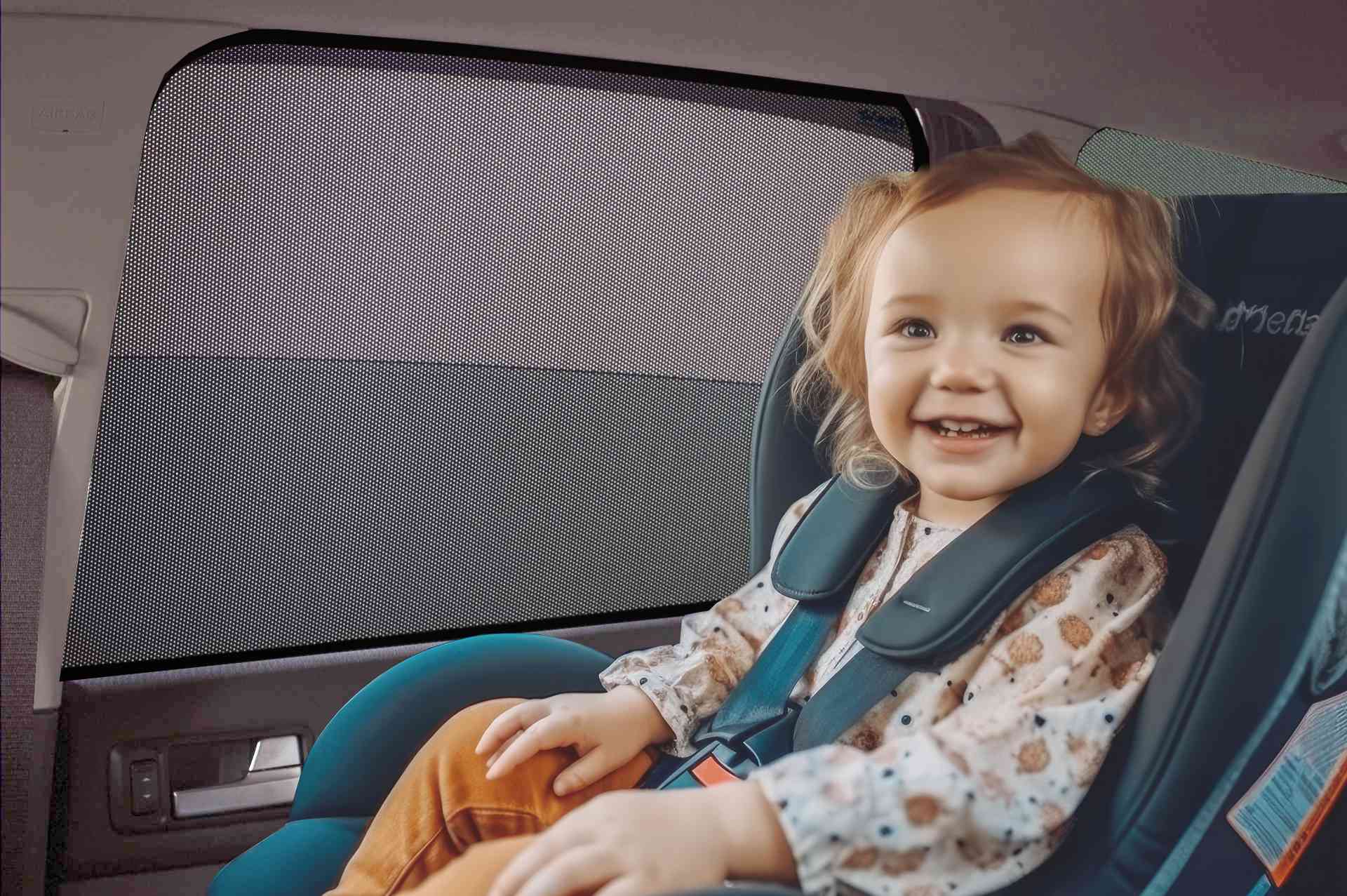 ein Kleinkind sitzt und lacht im Kindersitz auf dem Rücksitz eines Autos mit Sonnenschutzblende