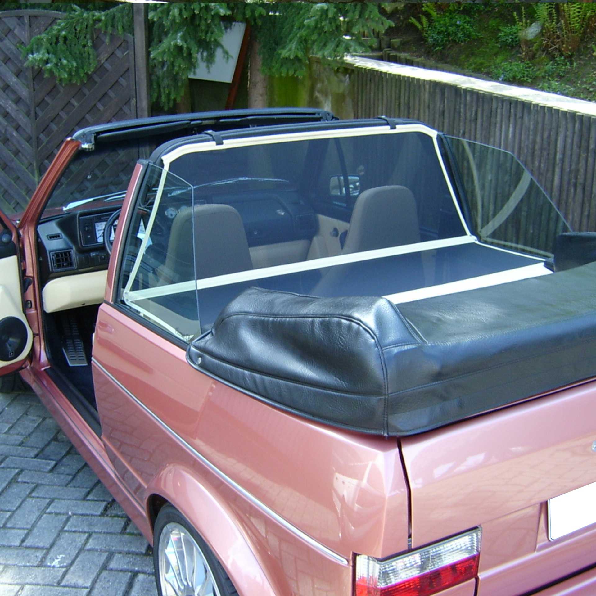 a red vw golf convertible with a bodi XLC wind deflector